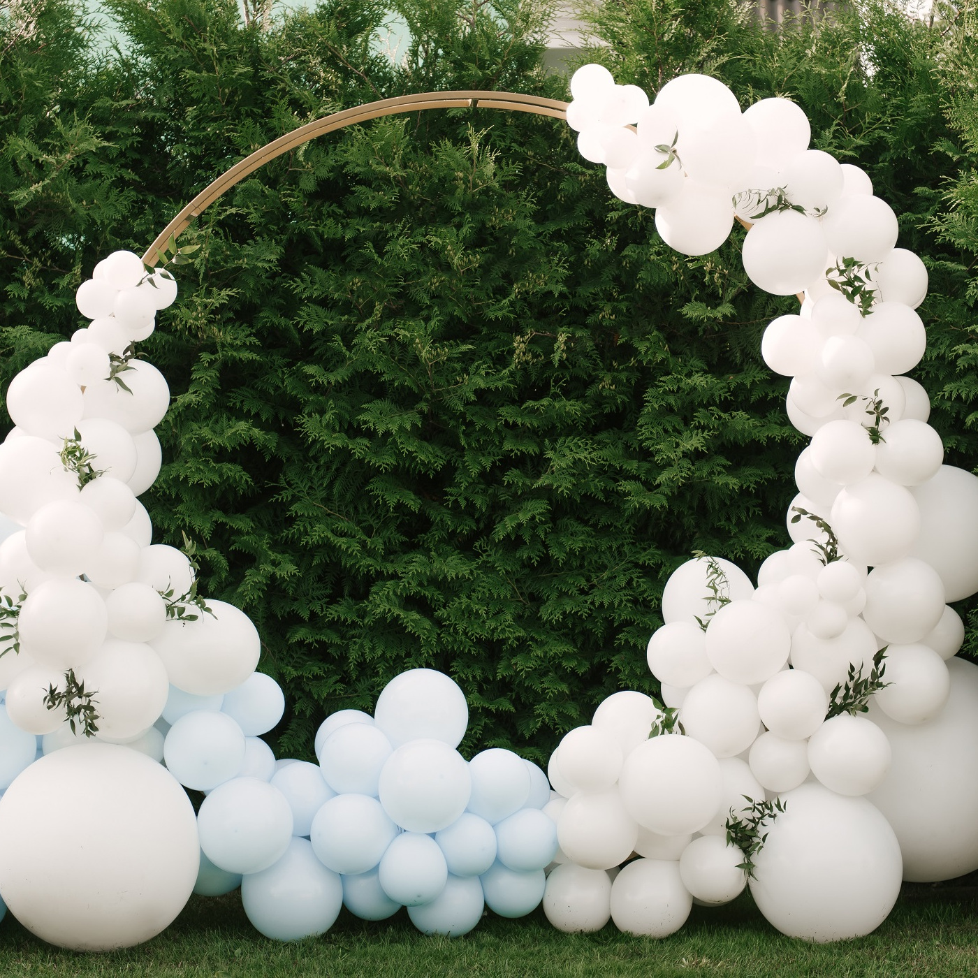 Decorations for holiday party. A lot of balloons blue and white colors. Round photo zone with balls